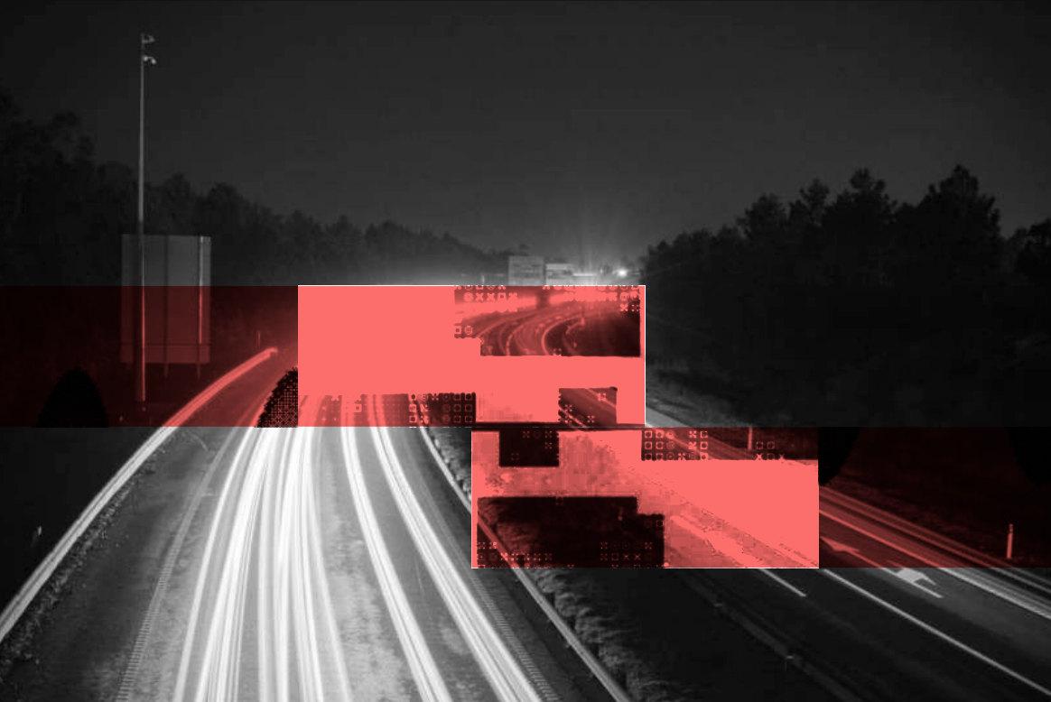A highway at night with light trails in black and white, crossed by coral glitch blocks